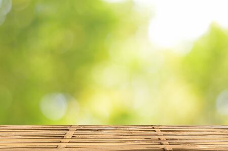 Empty wood table and green bokeh abstract background ,can be used for display your productsの写真素材