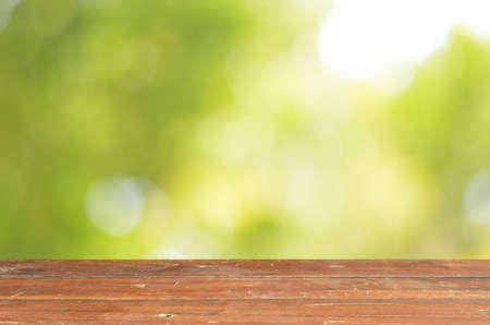 Empty wood table and green bokeh abstract background ,can be used for display your productsの写真素材