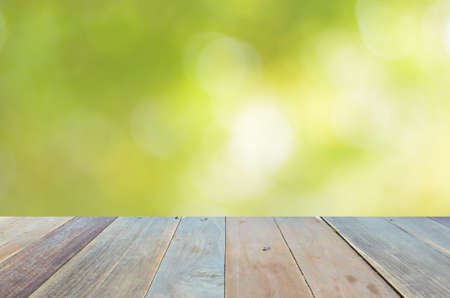 Empty wood table and green bokeh abstract background ,can be used for display your productsの写真素材