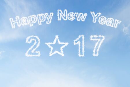 Happy new year 2017 and star shape cloud on blue skyの写真素材