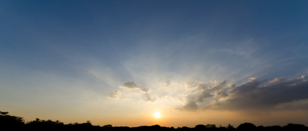 Beautiful sunbeam through cloud and sunset skyの写真素材