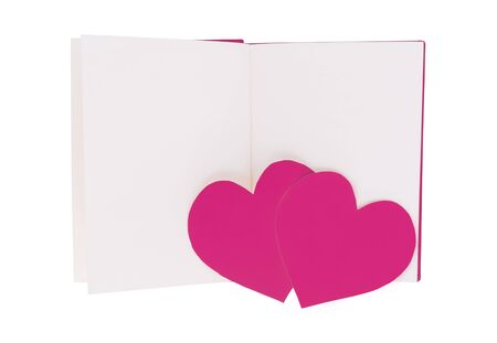 Couple pink paper heart on blank open book isolated on white backgroundの写真素材