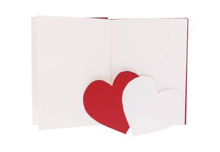 Red and white paper heart on blank open book isolated on white backgroundの写真素材