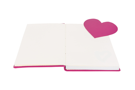 Paper heart on blank open book isolated on white backgroundの写真素材