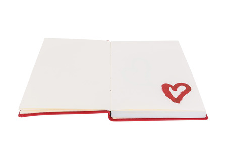 Open blank book with lipstick heart paint isolated on white backgroundの写真素材