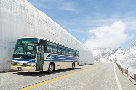 Toyama, Japan - May 20,2016: Tourists bus move along the japan alps snow wall at tateyama kurobe alpine routeのeditorial素材