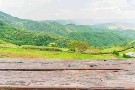 Empty wood table and blur green mountain backgroundの写真素材
