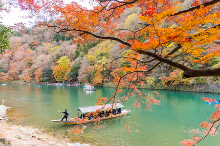 Kyoto, Japan - Nov 25, 2017: Arashiyama and Katsura river is the famous destination for tourist in autumn of japan. Many tourists sightseeing by japanese style boatのeditorial素材