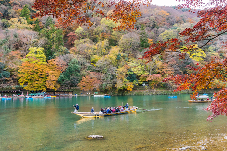 Kyoto, Japan - Nov 25, 2017: Arashiyama and Katsura river is the famous destination for tourist in autumn of japan. Many tourists sightseeing by japanese style boatのeditorial素材