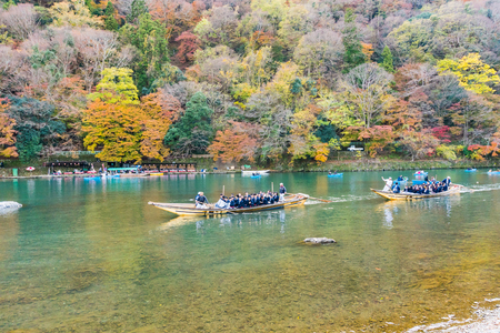 Kyoto, Japan - Nov 25, 2017: Arashiyama and Katsura river is the famous destination for tourist in autumn of japan. Many tourists sightseeing by japanese style boatのeditorial素材