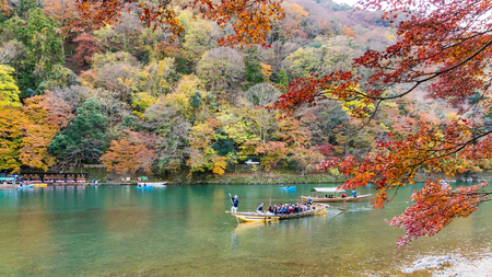 Kyoto, Japan - Nov 25, 2017: Arashiyama and Katsura river is the famous destination for tourist in autumn of japan. Many tourists sightseeing by japanese style boatのeditorial素材