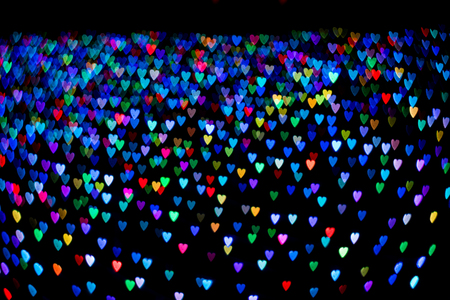 Heart shape bokeh on black abstract backgroundの写真素材