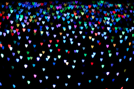 Heart shape bokeh on black abstract backgroundの写真素材