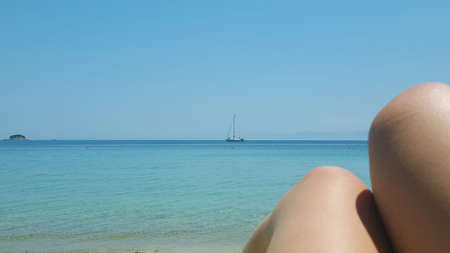 Beautiful Ambelakia beach on Skiathos island in Greece, summer day in June, sea view and a boatの写真素材