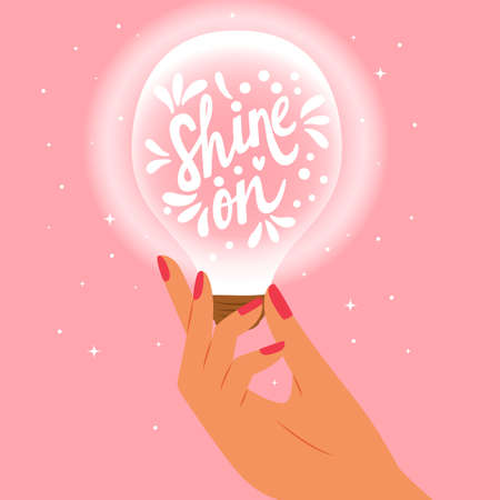 Female hand holding a light bulb with hand lettering. Shine on words. Colorful vector illustration.のイラスト素材