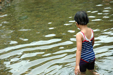 Girl playing in the waterの写真素材