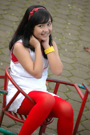 little girl sit down in parkの写真素材