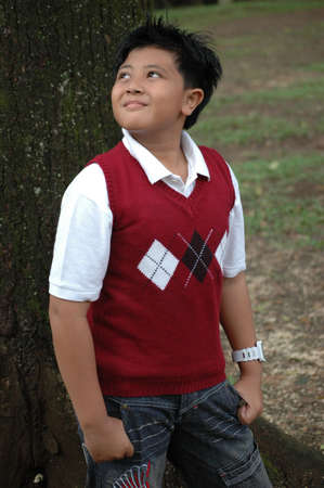 young boy looking to the topの写真素材