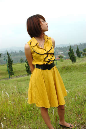 young lady wearing yellow gownの写真素材