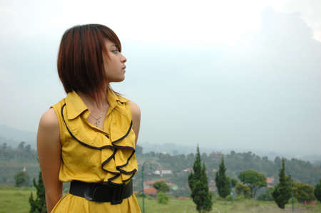 young lady wearing yellow gownの写真素材