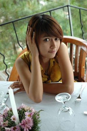 young lady sit down in chairの写真素材