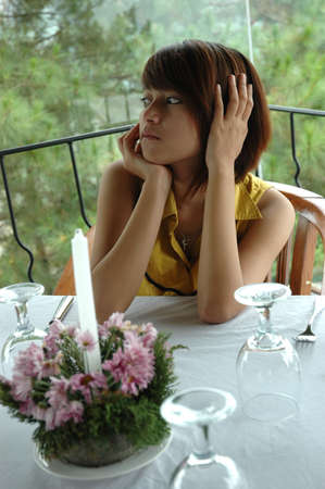 young lady sit down in chairの写真素材