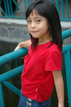 little girl stand up beside the fenchの写真素材