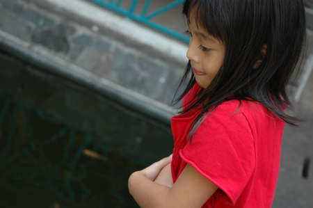 little girl stand up beside the fenchの写真素材