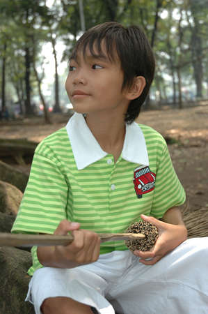 little boy sit down in park