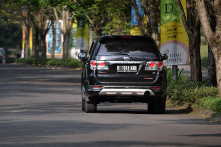 bandung, indonesia-june 9, 2014-black colored toyota fortuner cruising on the roadのeditorial素材