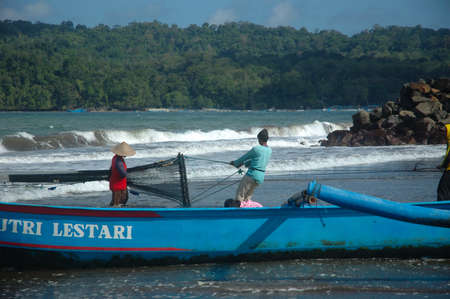 pangandaran, indonesia-july 16, 2011  fisherman at pangandaran beach, west java-indonesia のeditorial素材