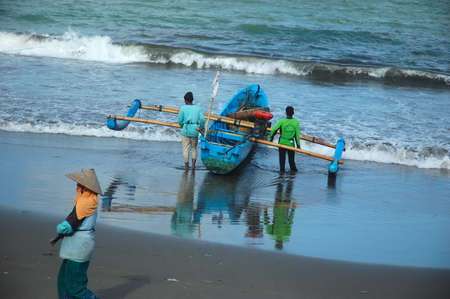 pangandaran, indonesia-july 16, 2011  fisherman at pangandaran beach, west java-indonesia のeditorial素材