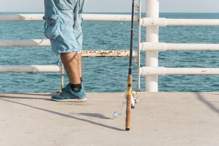 A Man Putting His Fishing Rod on the Ground and Waiting for fishes