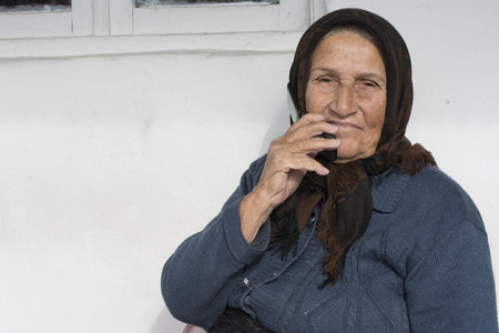 Chokam, IRAN - December 16, 2016 Close Up Portrait of an Elderly Muslim Woman Using a Cell phone. Gilan Provinceのeditorial素材