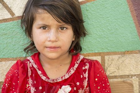 Tehran, IRAN - August 16, 2017 Portrait of a little girl selling small tissue packages at street pavementのeditorial素材