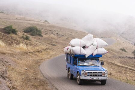 30dasht, IRAN - July 27, 2018  Mountain side road, car passing through fogy road, Gilan province