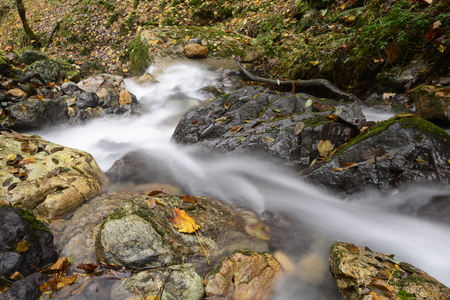 Waterfall at mountain river on stones flowing to down part. Nature landscape sceneの写真素材