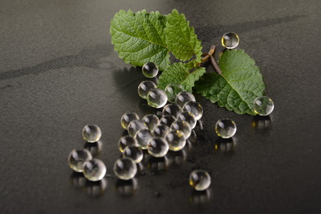 Fresh mint leaf on a table with transparent jelly pills