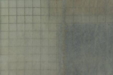 Matt transparent plate in front of metal bars squares, abstract textures