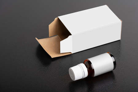 Child dietary supplement glass bottle with package on dark background, editable mock-up series template ready for your design, selection path included.の写真素材