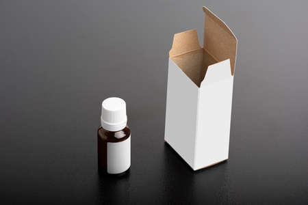 Children dietary supplement glass bottle with package on dark background, editable mock-up series...