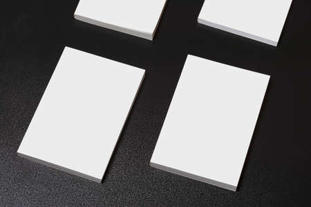 Multiple books with blank cover on dark glossy table, editable mock-up series ready for your design,...