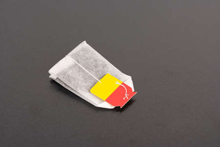 A small tea bag on dark background, editable mock-up series template ready for your design,...