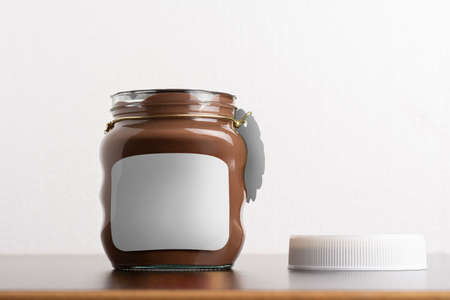 Hazelnut spread chocolate jar with round cap on black table, editable mock-up series template ready for your design, label selection path included.の写真素材