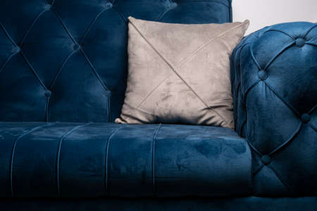 Blue velvet sofa with gray cushion, modern sofa texture with sunken buttonsの写真素材
