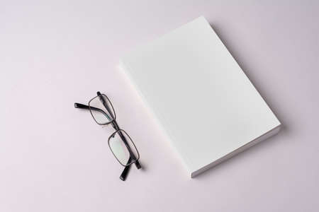 Closed novel book with blank cover on table, editable mock-up series template ready for your design, cover selection path icluded.の写真素材