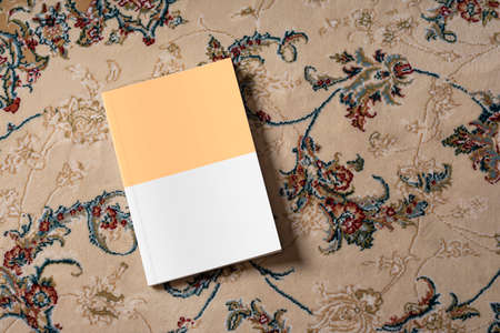 A story book on a carpet with beautiful pattern, editable mock-up series ready for your design, book...