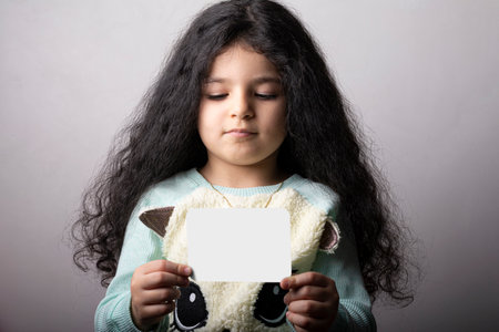 Little girl portrait holding a flash card in hand, preschool educational material learning objects. flash card selection path included.の写真素材