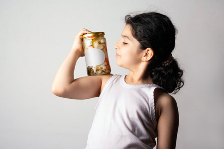 Little girl holding a pickled glass conserve, editable PSD mock-up series with smart object layersの写真素材