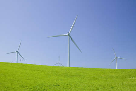 Wind turbines on green hillの写真素材